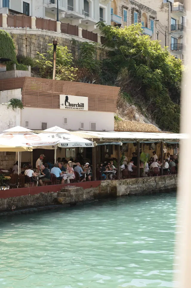 Churchill Restaurant terrace beside the water in Xlendi